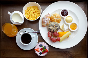 Rich continental breakfast. French crusty croissants, muesli, lots of sweet fruits and berries, hot coffee for morning meals.