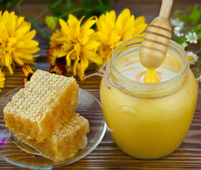 Delicious delicious honey in  jar on table