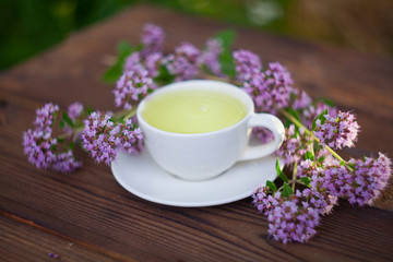 delicious  oregano tea in a beautiful glass bowl on table