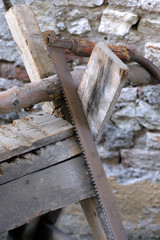 old long wood saw blade on wooden log