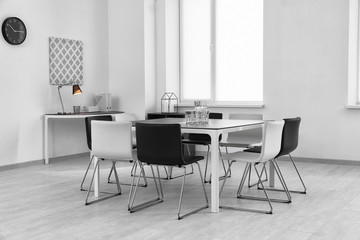 Modern room interior with big table and chairs
