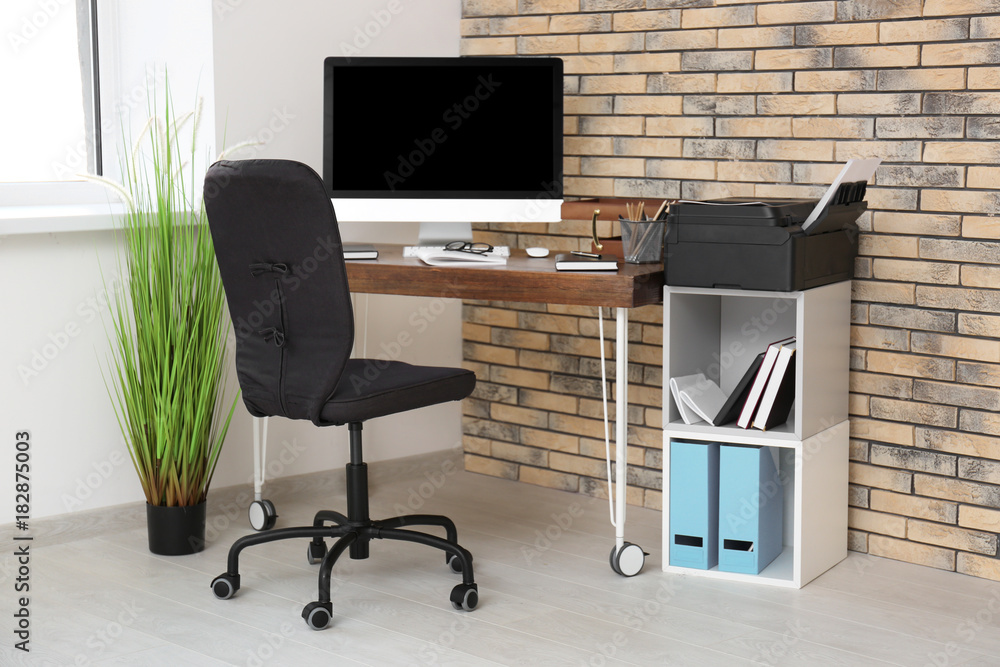 Wall mural Comfortable workplace with computer monitor on table in office