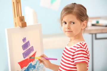 Little girl painting at home