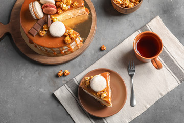 Beautiful composition with delicious caramel cake on table