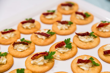 Cheese canape with chili on crackers