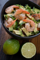 Close-up of salad with avocado, cucumber and shrimps, elevated view, selective focus