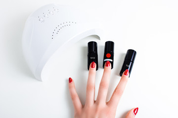 isolated background. manicure, coating with gel varnish. concepts of drying gel varnish in ultrafiolet lamp, UV lamp. 