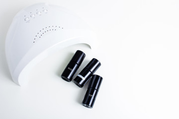 isolated background. manicure, coating with gel varnish. concepts of drying gel varnish in ultrafiolet lamp, UV lamp. 