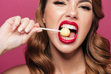 Pretty funny lady eating lollipop like watermelon isolated