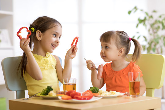 children eating food in kindergarten or at home