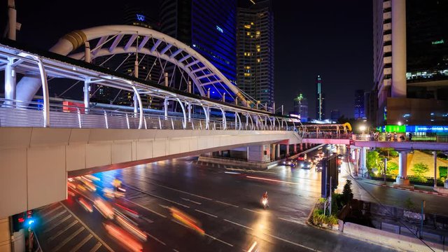 4k Time-lapse of public sky walk and traffic at Chong Nonsi sky train station at night, Bangkok, Thailand