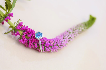 Round topaz engagement ring on natural romantic background