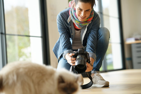 Woman photographer taking pictures of cat