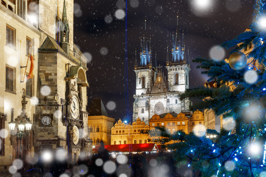 Old Town Hall with astronomical clock, Town Square with Christmas tree and fairy tale Church of our Lady Tyn in the magical city of Prague at snowy night, Czech Republic