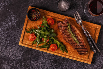 Beef steak on a dark background.