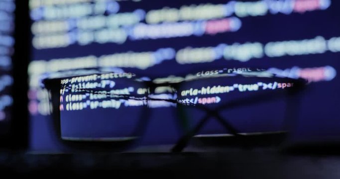 Cyber attack concept. glasses on the keyboard, on the background of the monitor