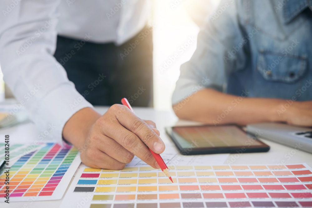 Aufkleber two interior design or graphic designer at work on project of architecture drawing with work tools a