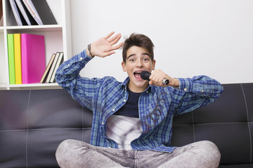 children, teenager or preteen with the microphone singing at home