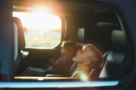 Two kids riding in a car