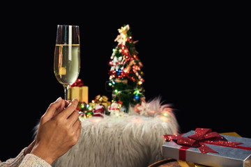 Beautiful women holding glasses with champagne celebrating Christmas and gift boxes at corporate party, New Year Frame for your text
