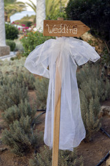 Wedding signpost arrow with white veil