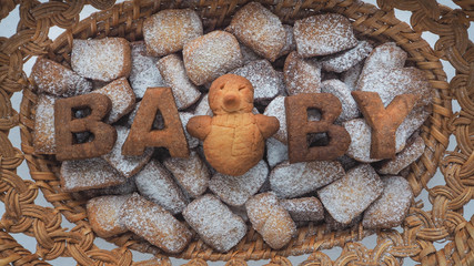 Word Baby biscuit over the biscuit background