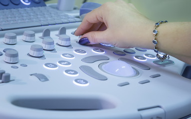 Qualified medical specialist using ultrasound equipment in the clinic