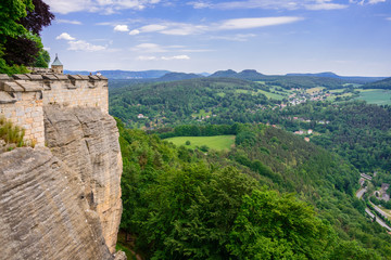 Fototapeta na wymiar The German village of Hutten. Saxon Switzerland, Germany. View from the fortress Koenigstein. Fortress wall of the fortre