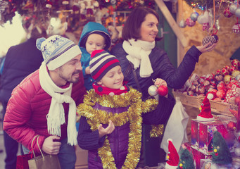 Charming parents with children with Christmas decoration