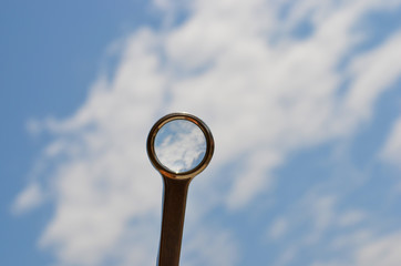 Magnifying glass and sky with clouds