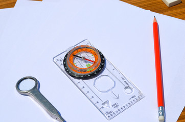 White paper Pencil Compass with a transparent ruler and Magnifying glass wood