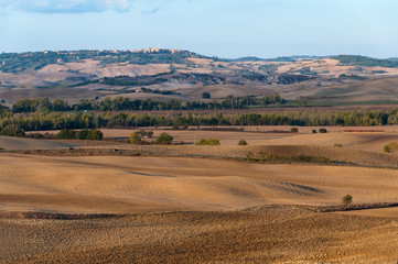 Fototapeta premium Beautiful rural autumn landscape of Val d'Orcia on the background Pienza, Tuscany, Italy.