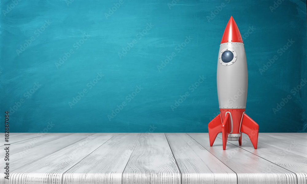 Poster 3d rendering of a red and silver realistic model of a retro rocket stands on a wooden desk on a blue