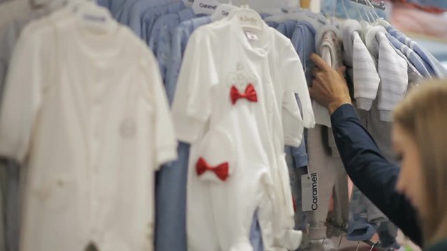 Future parents choose the clothes to their baby