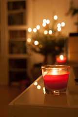 Red candles lighting a house in Christmas time