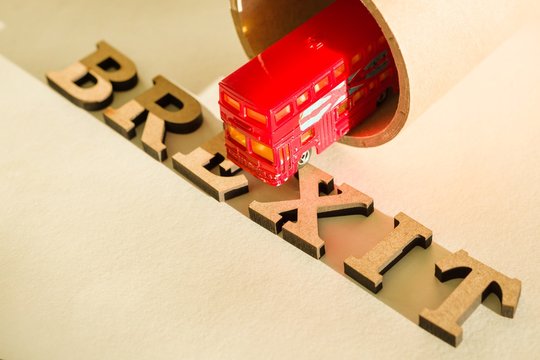 Britain exit from European Union, Brexit word abstract in vintage letters,background double decker bus toy model, tunnel