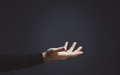 male hand on a dark background