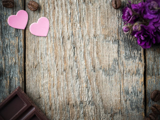 Fototapeta premium Decorations for Valentines day paper hearts, violets and chocolate coffee on rustic wooden background