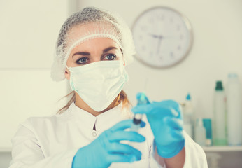 Female nurse preparing injection