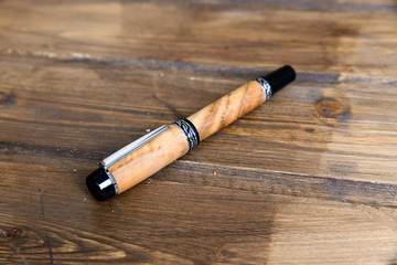 wooden writing pen on a wooden table