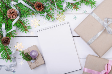 Christmas tree background and blank notebook for your text, top view.