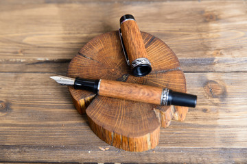wooden writing pen on a wooden table - 182891228
