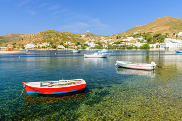 Fototapeta na wymiar Colorful fishing boats in the picturesque Bay of Grikos, a popular tourist site on the island of Patmos, Dodecanese, Greece 