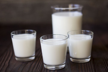 rustic dairy products, glass of milk on a wooden table