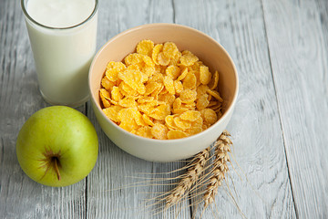 yogurt,cereal and an Apple for a healthy Breakfast
