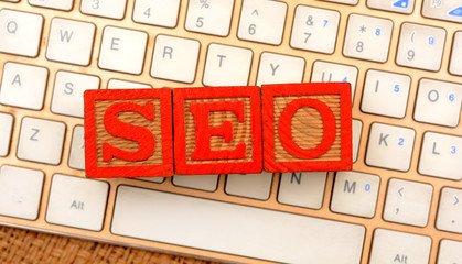 SEO word blocks on laptop keyboard closeup