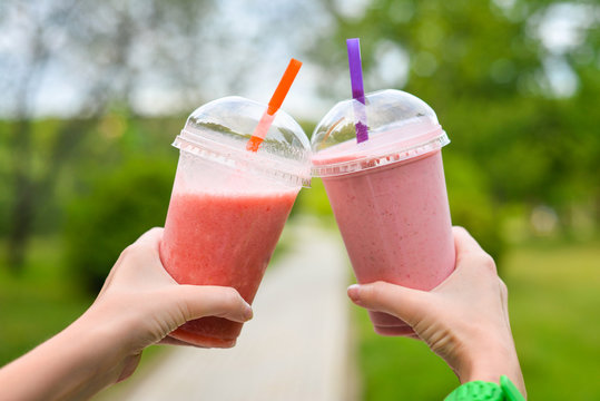 Pink smoothies in hand