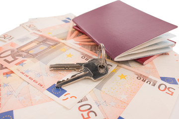 Passports on banknote background. Passports and keys of house. Euro banknotes 50 fifty. Traveling and money.