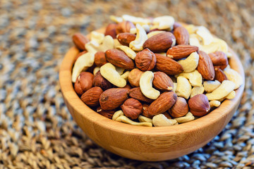 Assorted nuts in wooden bowl