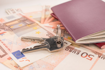 Passports on banknote background. Passports and keys of house. Euro banknotes 50 fifty. Traveling and money.